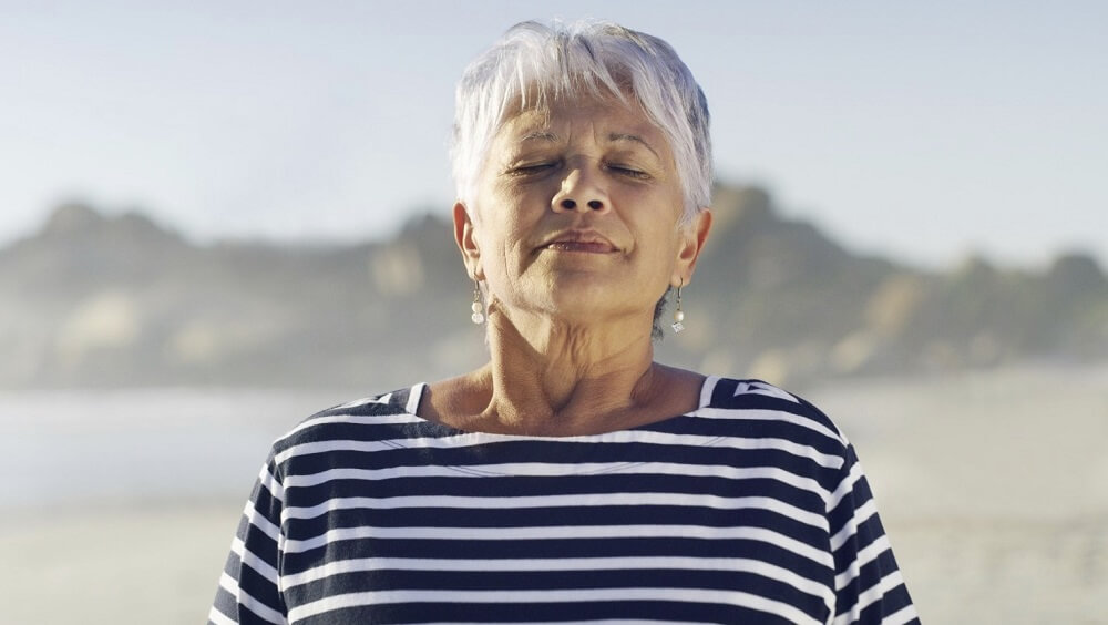 An old lady inhaling fresh air