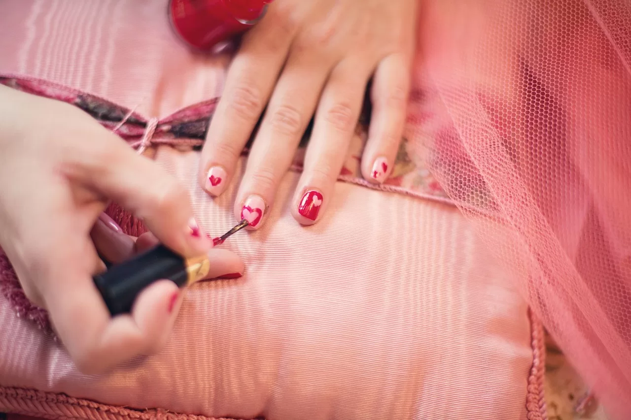 A lady painting fingernails