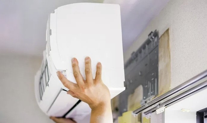 A person installing an air con